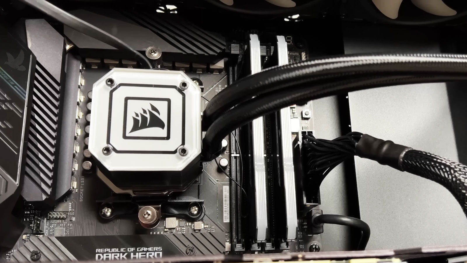 Corsair liquid CPU cooler installed in a high-performance gaming PC with dual coolant hoses