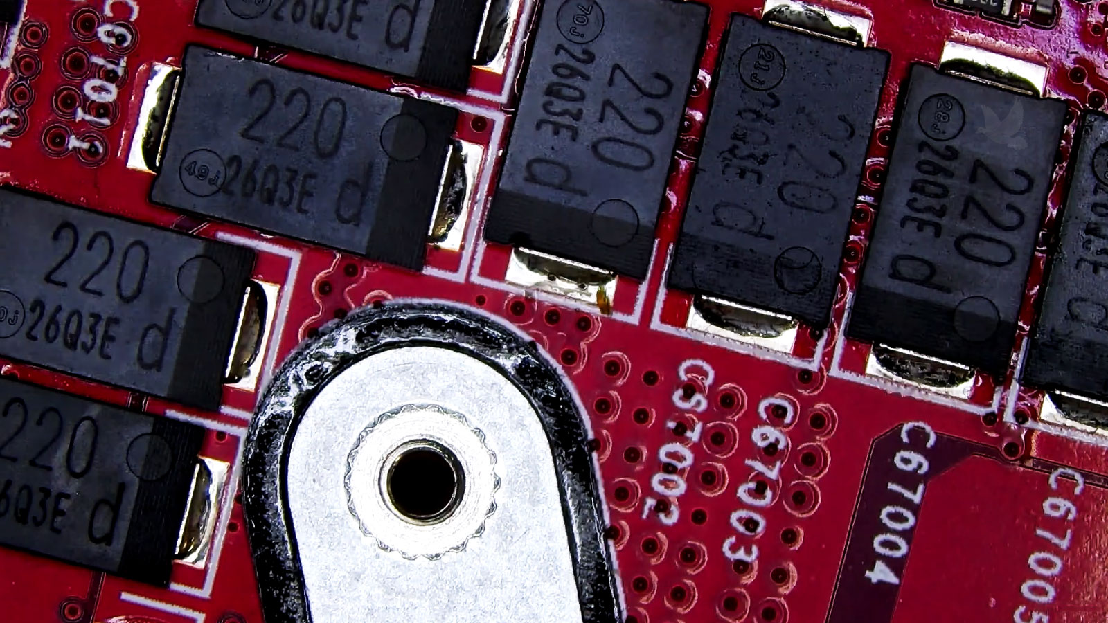 Damaged 220 SMD capacitor among similar components near the CPU area of a computer circuit board