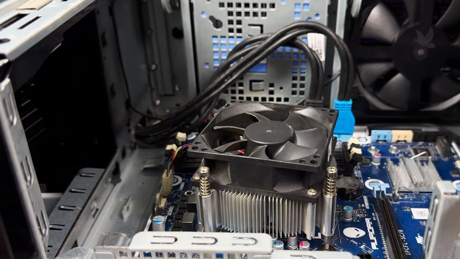 Dell Alienware PC motherboard being inspected for component damage after the computer failed to power on