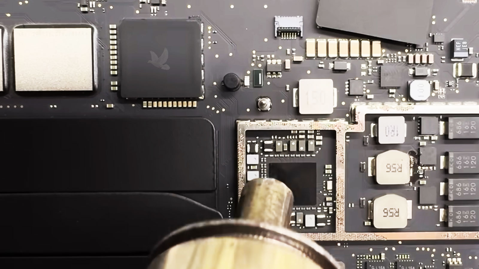 MacBook-Pro-IC-Removal-with-Hot-Air-Rework-Station MacBook logic board undergoing IC removal with a hot air rework station