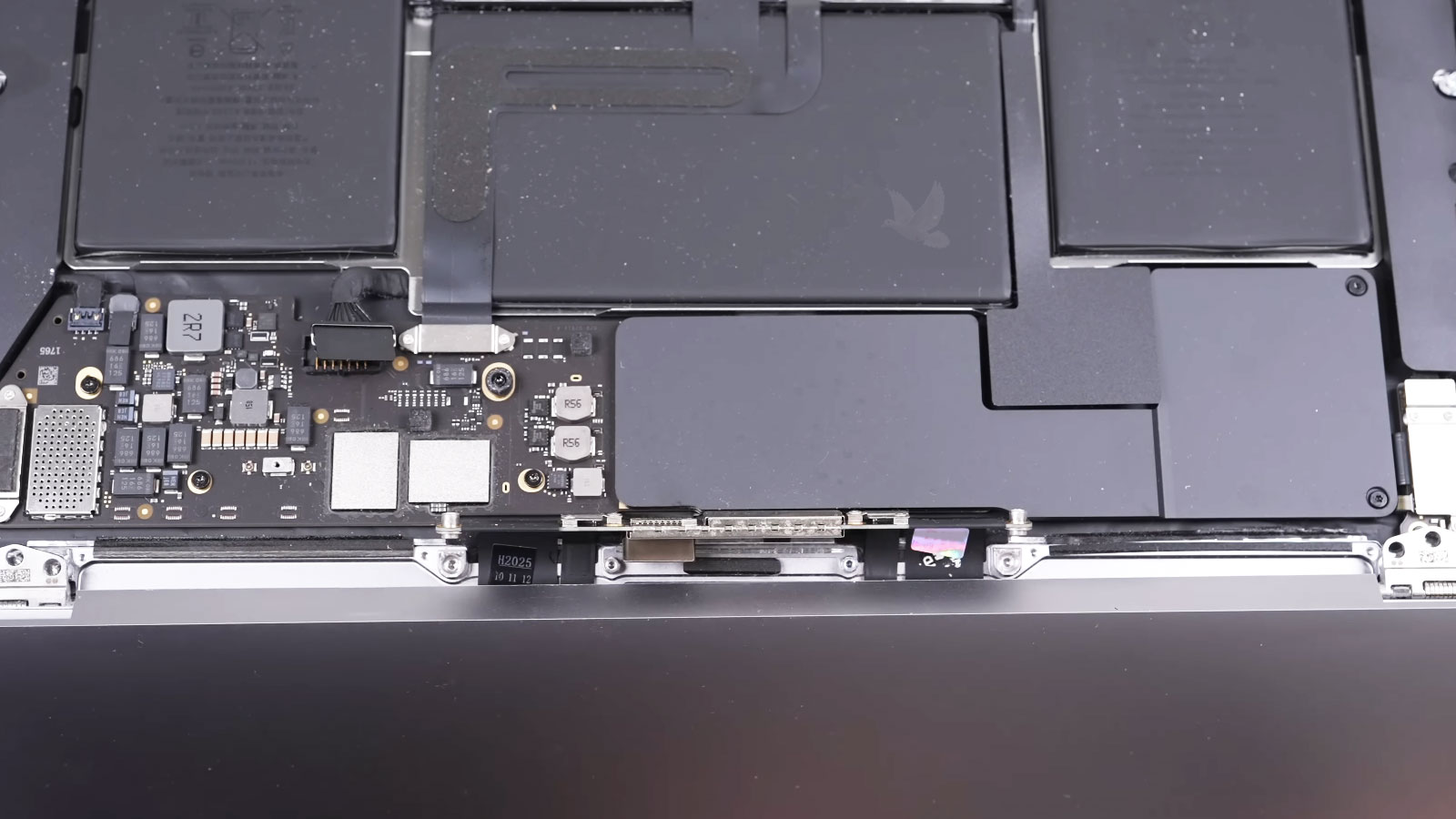 Replacement MacBook Pro LCD screen assembly being reconnected to the laptop after repair