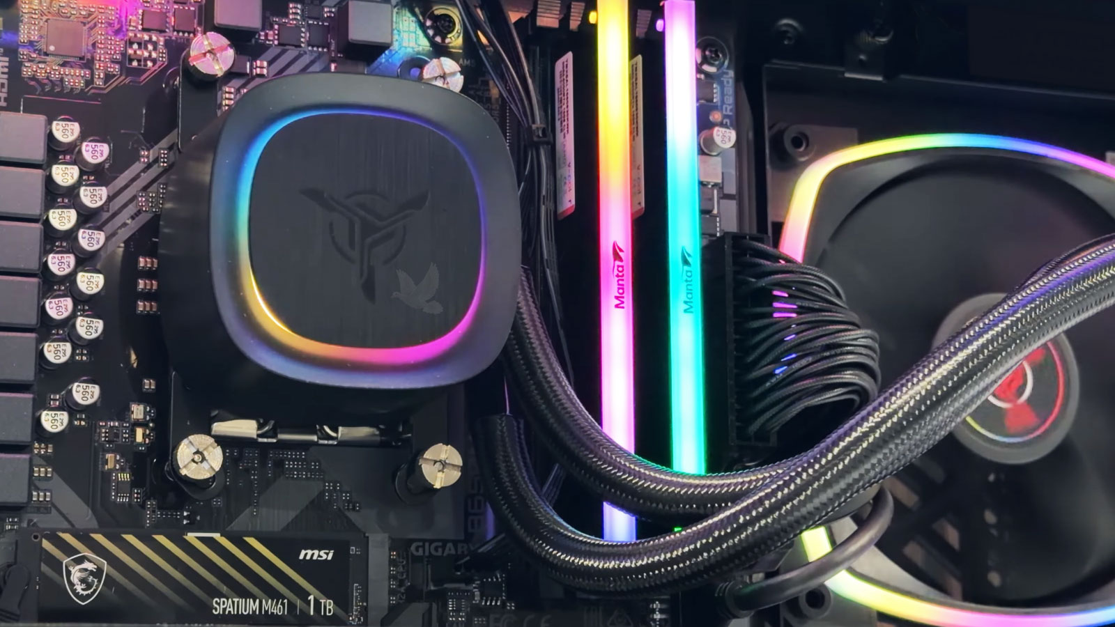 RGB-Gaming-PC-Internal-Components Gaming computer interior with RGB-lit CPU cooler, memory modules, and cooling fans