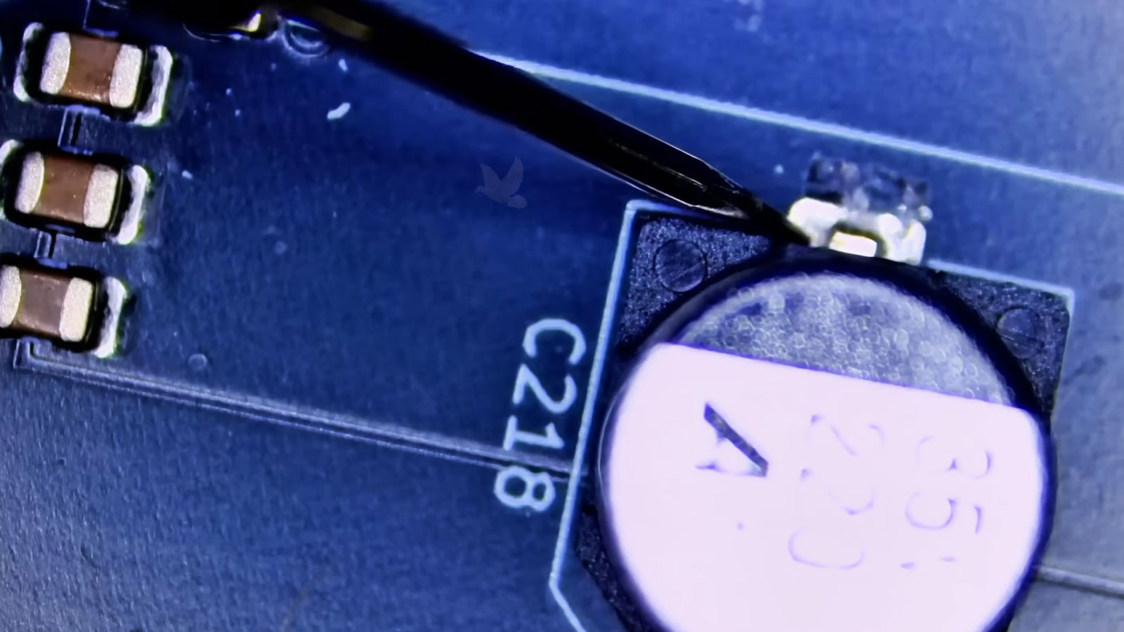 C218 capacitor being measured after laptop diagnostics identified it as the faulty component