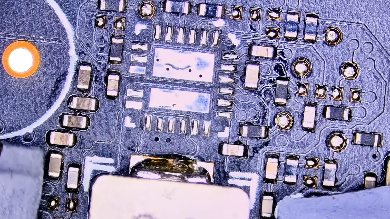 Computer circuit board with a damaged IC removed and solder pads cleaned for replacement