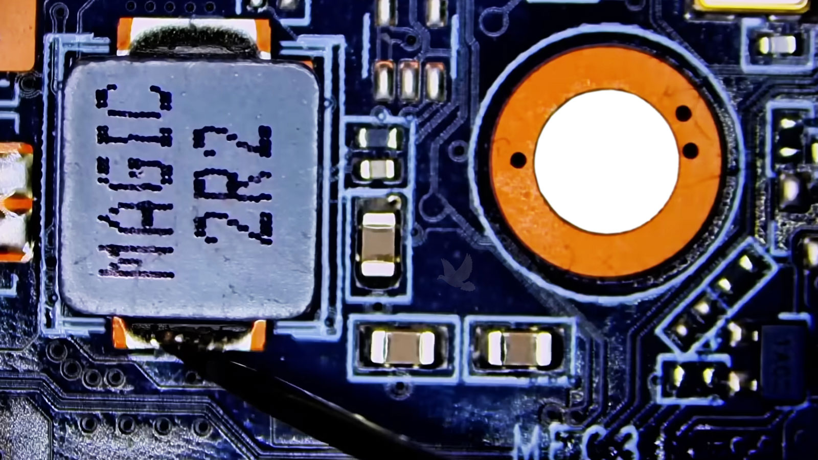 Computer motherboard repair testing low resistance at a coil indicating a possible short circuit on the power rail