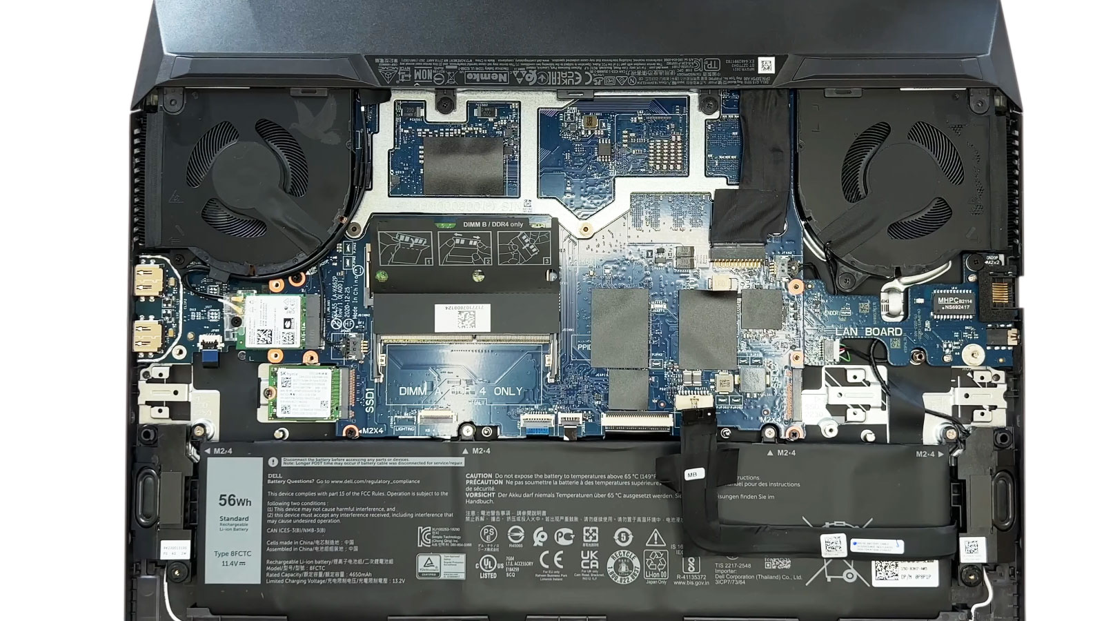 Original SSD being removed from an open Dell laptop for data transfer to a new SSD
