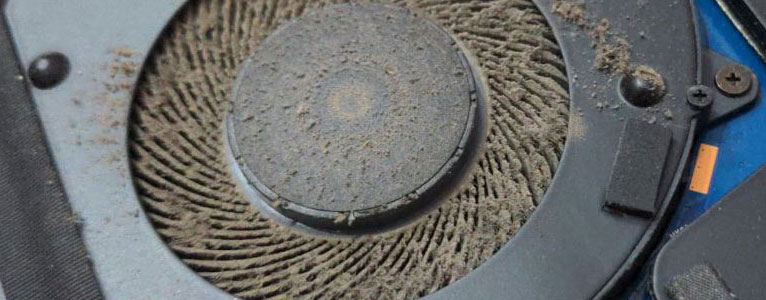 Dust-Clogged-Laptop-CPU-Cooling-Fan Laptop CPU cooling fan clogged with heavy dust, dirt, and debris during cleaning and maintenance