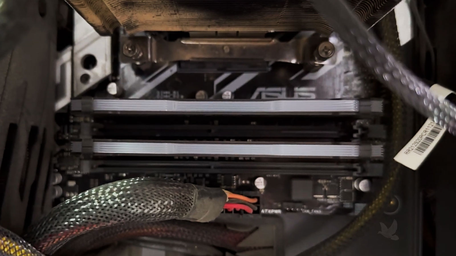 Dust buildup on the heatsink of a gaming PC with an ASUS motherboard during cleaning