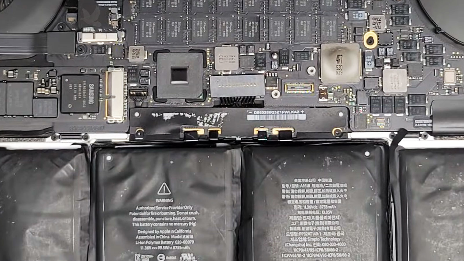MacBook Pro with swollen battery exposed after removing the back cover