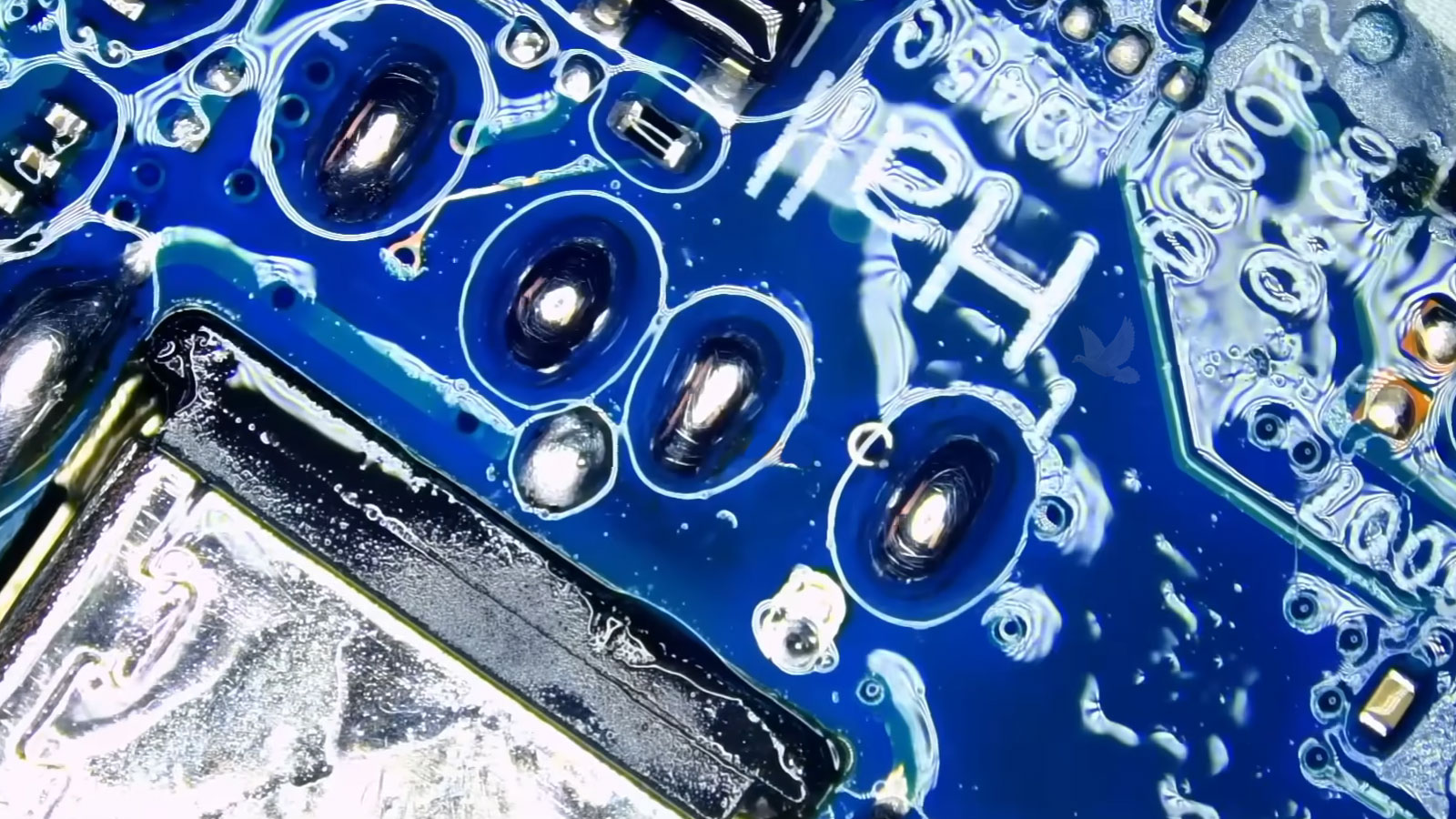 Laptop DC power jack being repaired by resoldering its connection points on the circuit board