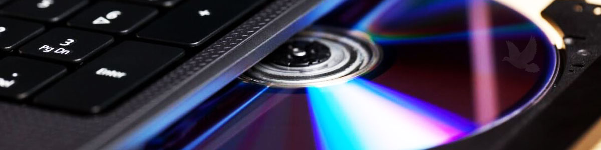 Laptop DVD drive open with a DVD disc inserted in the tray