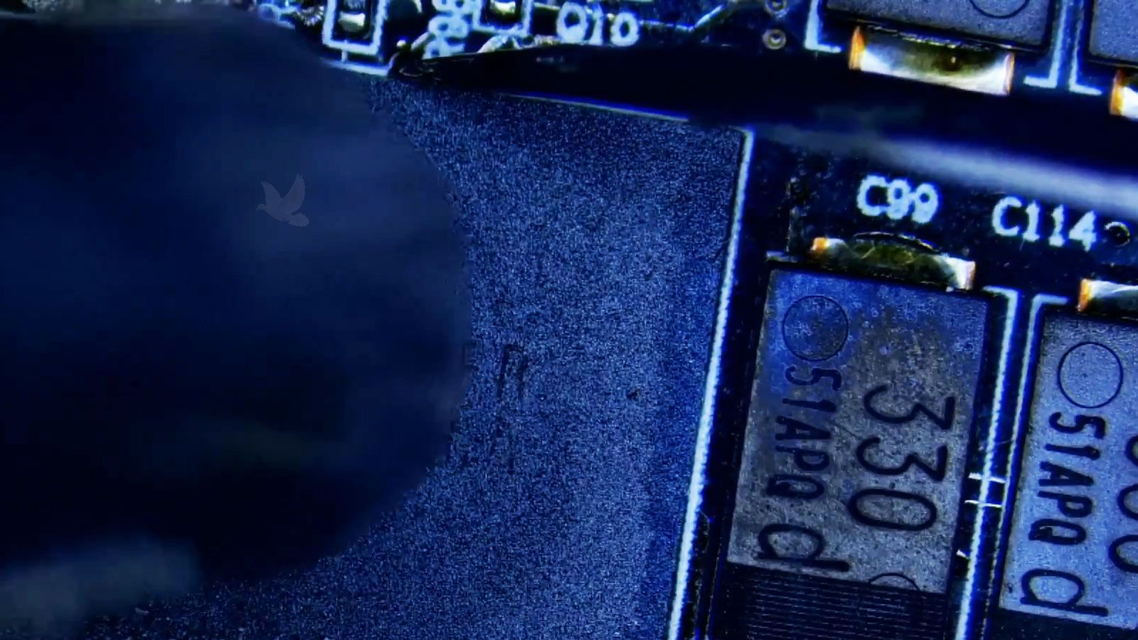 Laptop-GPU-Power-IC-Replacement Faulty IC chip being removed near a laptop GPU with a hot air rework station