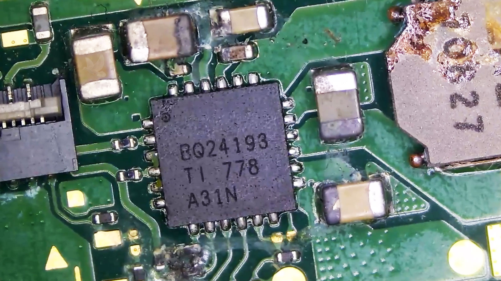 Laptop-Motherboard-Liquid-Damage-and-Corrosion-Repair Laptop motherboard with visible liquid damage and corrosion around the BQ24193 chip and nearby components