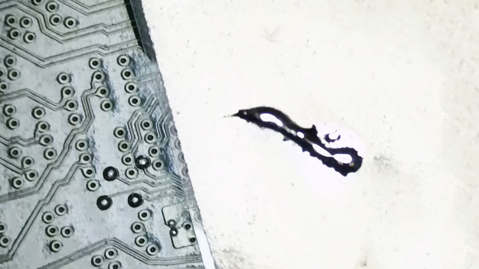 Laptop motherboard undergoing component level repair after damage caused by spilled liquid metal