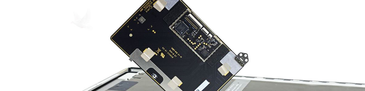 Laptop touchpad removed and lifted above the bottom case during repair