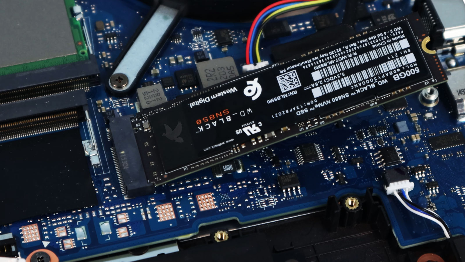 M.2 SSD being accessed inside an open laptop during data recovery