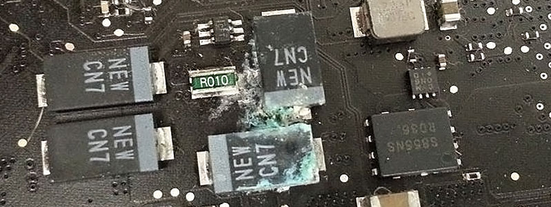 MacBook-Air-Liquid-Damage-Repair-with-SMD-Corrosion MacBook Air liquid damage repair with green corrosion visible around SMD capacitors on the motherboard