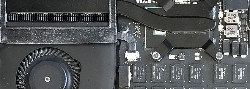 Dirt and debris around the MacBook Pro CPU heatsink and cooling fan assembly