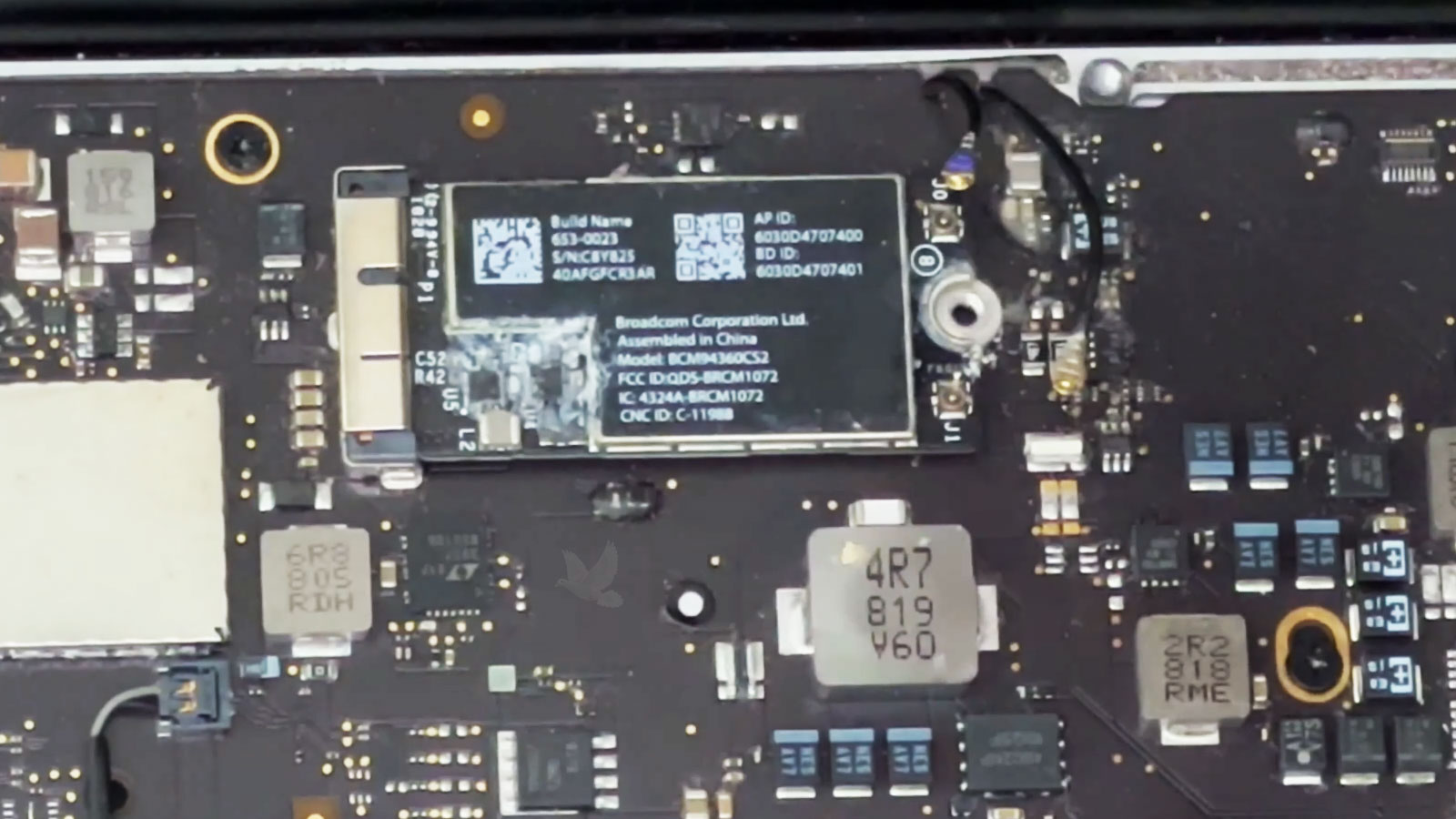 MacBook Pro Wi-Fi card with visible corrosion from liquid exposure