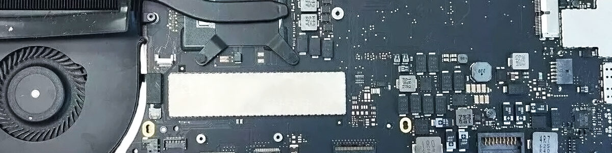 MacBook Pro logic board with heatsink and cooling fan attached for diagnostic testing