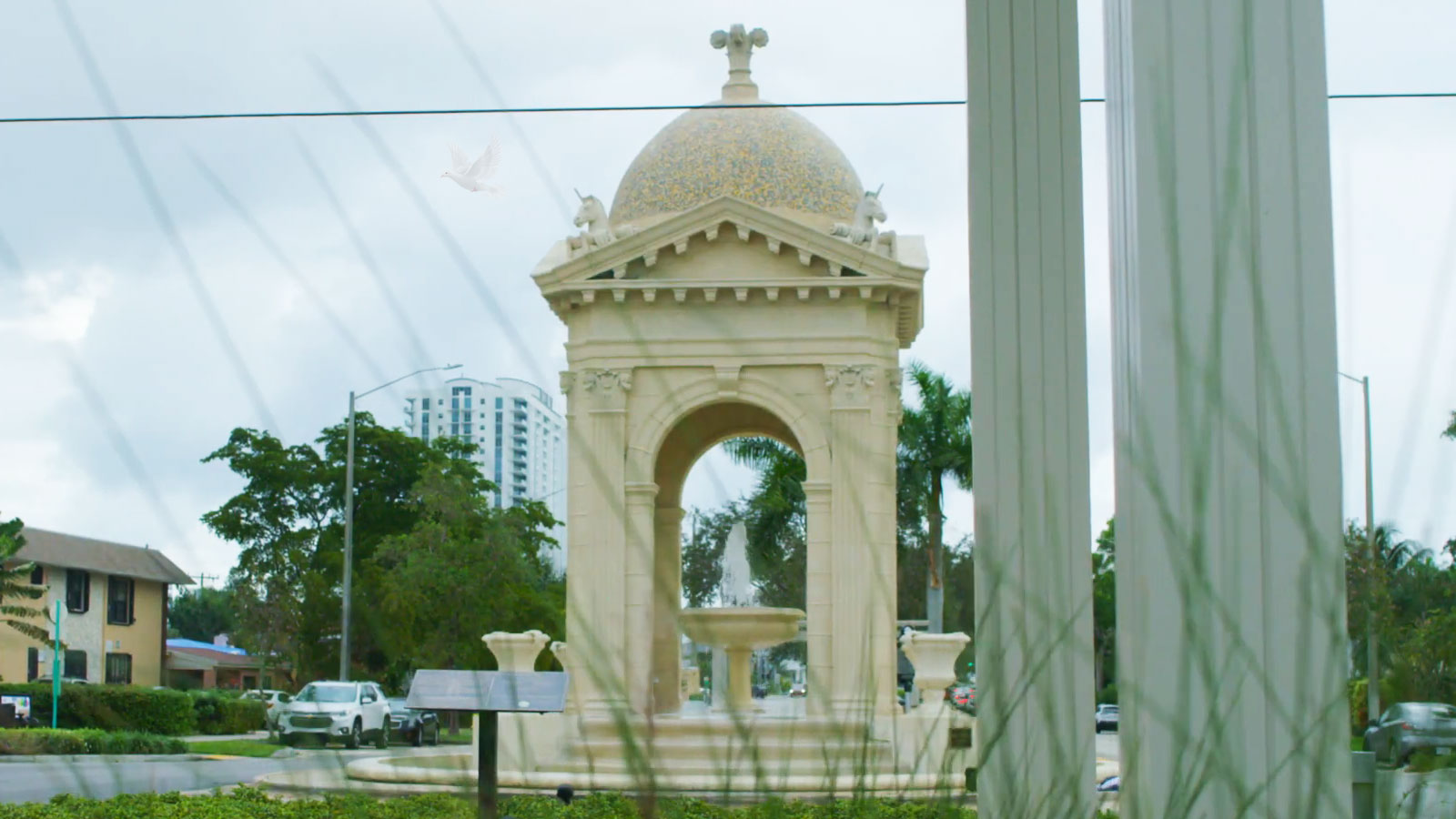 Fulford by the Sea entrance in North Miami Beach with flowing water and palm trees on both sides