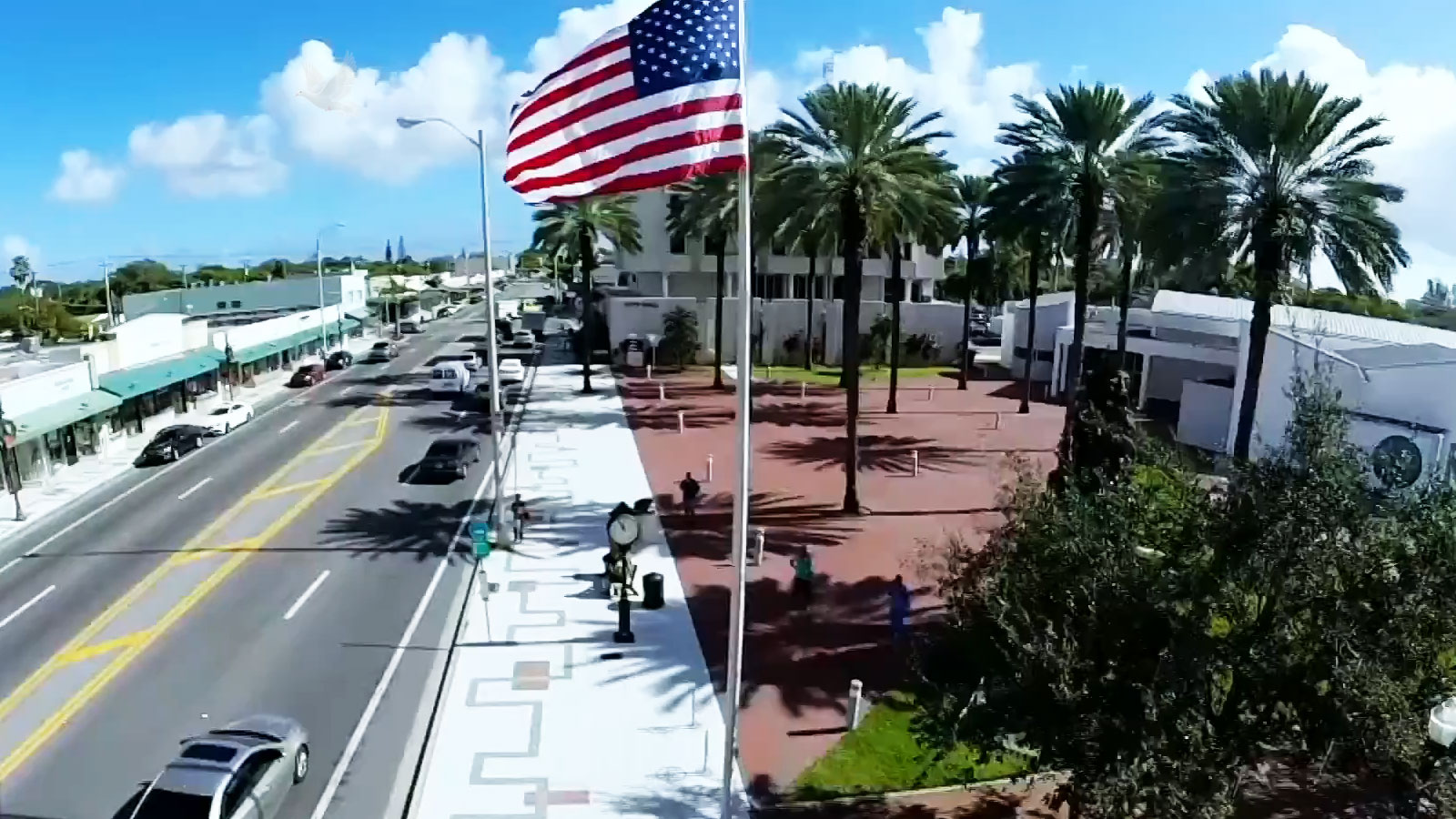 North-Miami-City-Hall North Miami City Hall with an American flag, sidewalk clock, and palm trees in front of the building