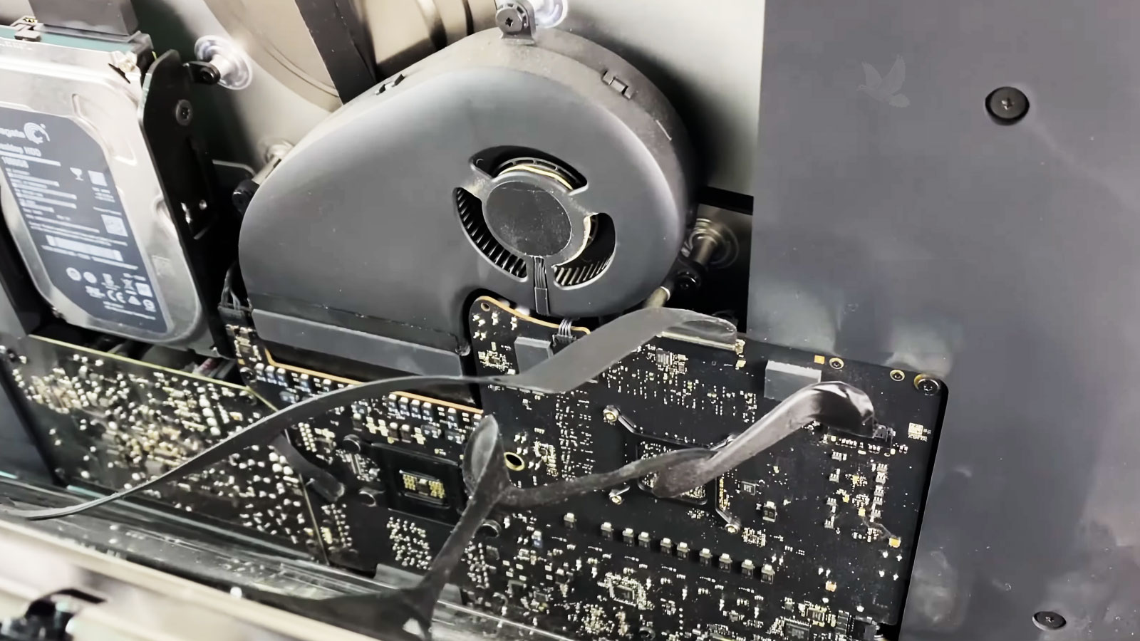 iMac with the LCD partially removed and display cables still connected during screen repair