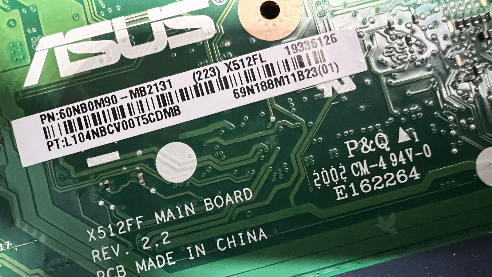 ASUS motherboard model and part numbers printed on back of main board