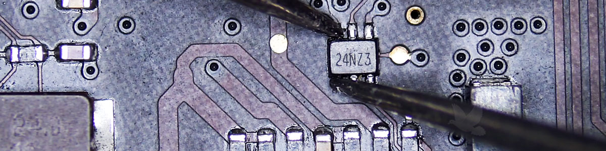 Apple logic board IC marked 24NZ3 being measured across two pins during circuit diagnosis