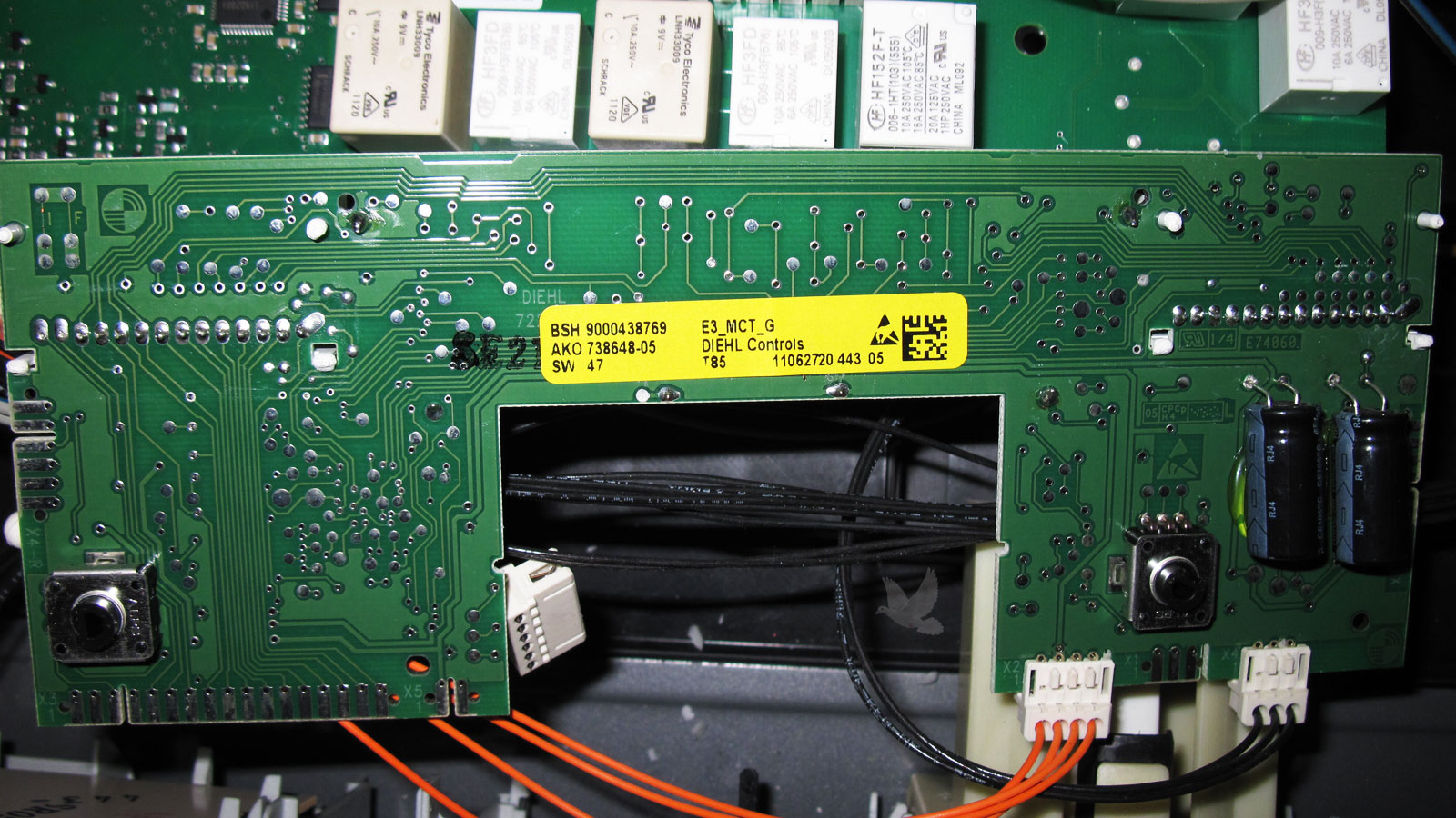 BSH 9000438769 electronic circuit board showing two replaced capacitors on the right side following component-level repair.