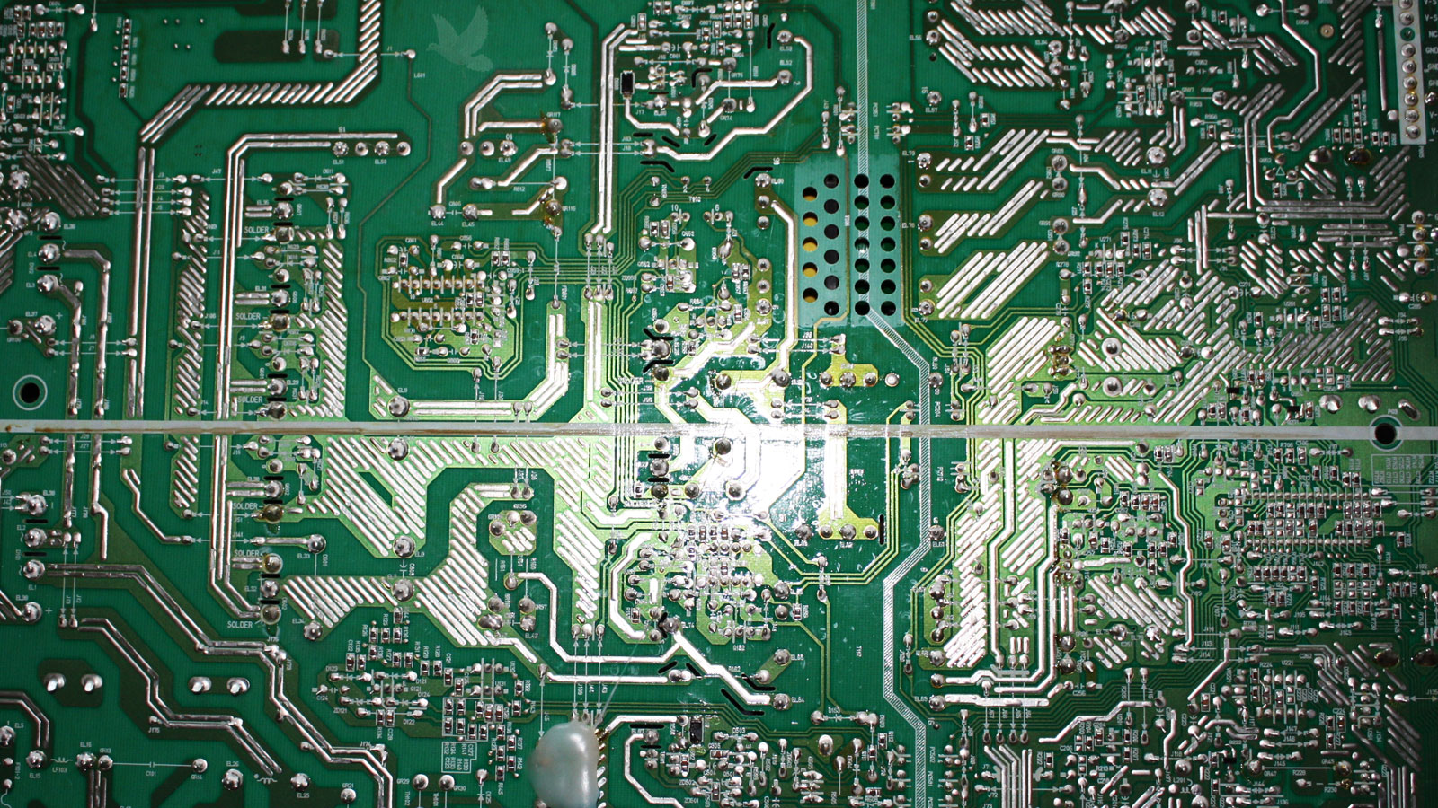 Back of circuit board inspected for cracked or damaged solder joints