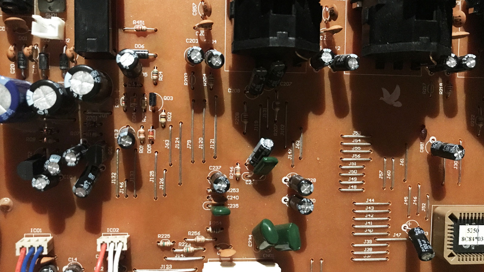 Circuit board showing multiple small capacitors replaced after several were found to have elevated ESR, restoring normal board operation