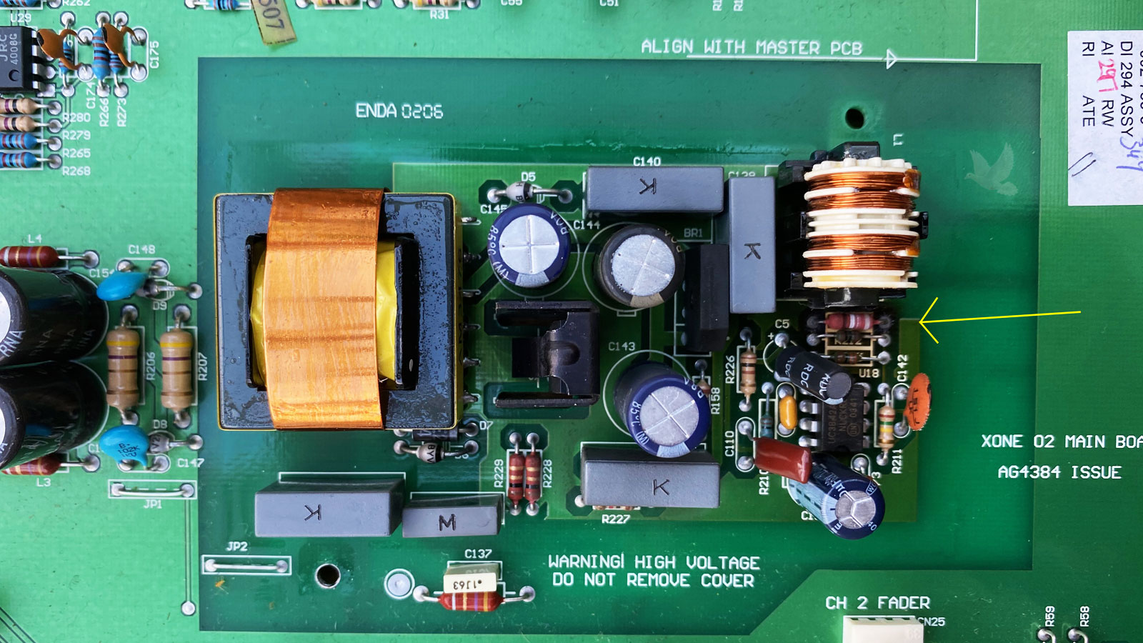 Circuit board with a yellow arrow identifying an overheating resistor, indicating a possible short circuit involving nearby electronic components.