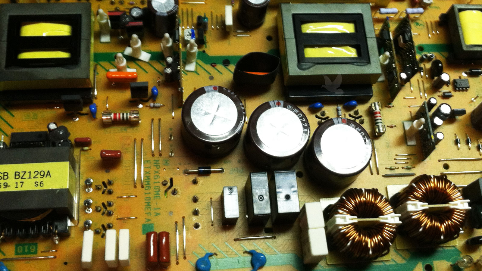 Circuit board showing a replaced transformer and two newly installed fuses following component failure, with the board restored to proper working condition.