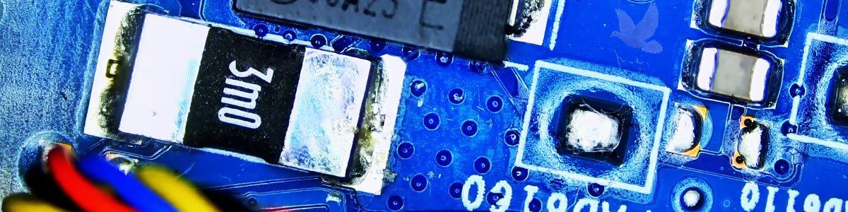 Computer circuit resistor being measured during diagnosis of an electrical short