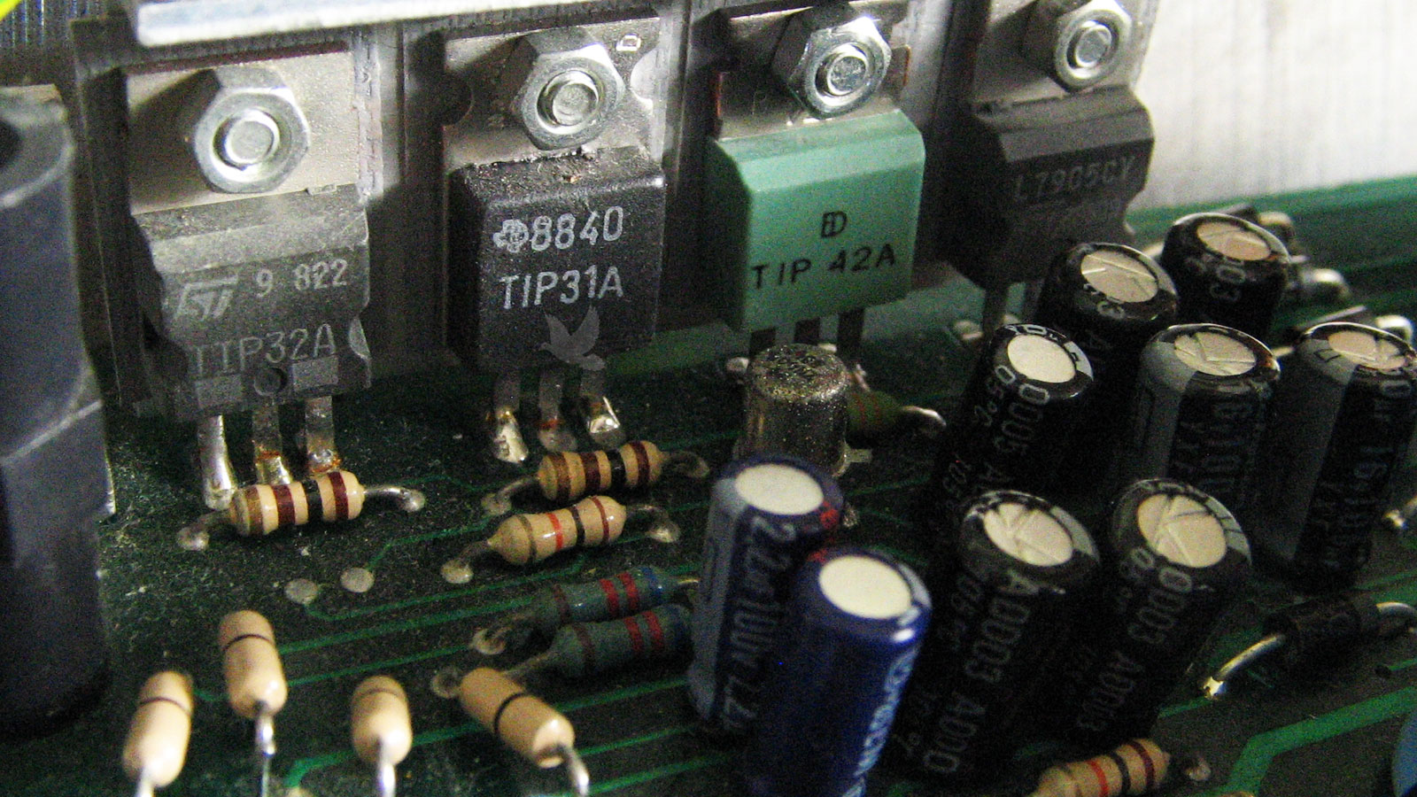 Circuit board showing a damaged 8840 transistor, second from left to right, identified during inspection and requiring replacement.
