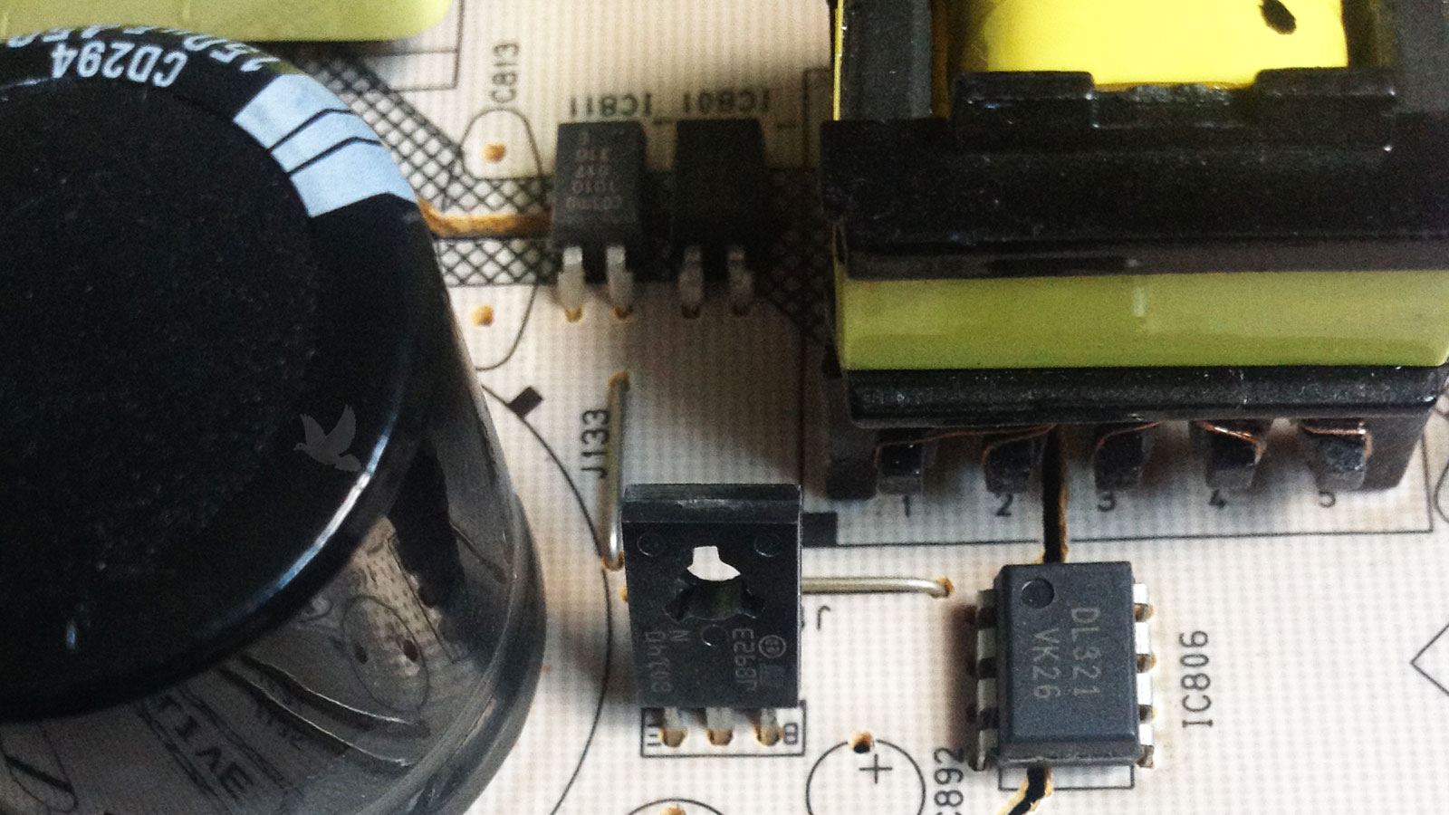 Damaged IC811 optocoupler beside second optocoupler on circuit board