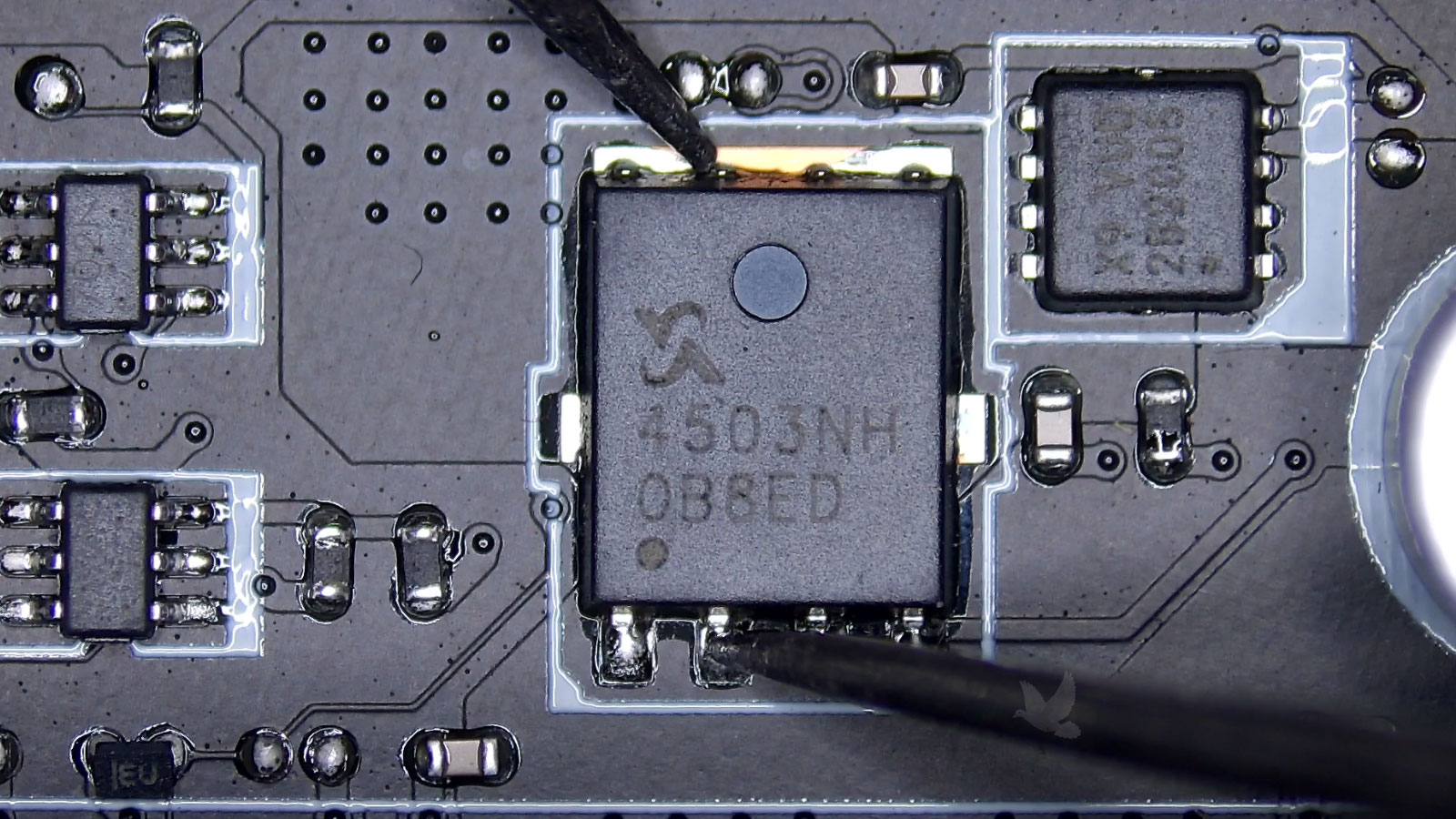 Damaged small MOSFET next to a working 4503NH MOSFET on a circuit board