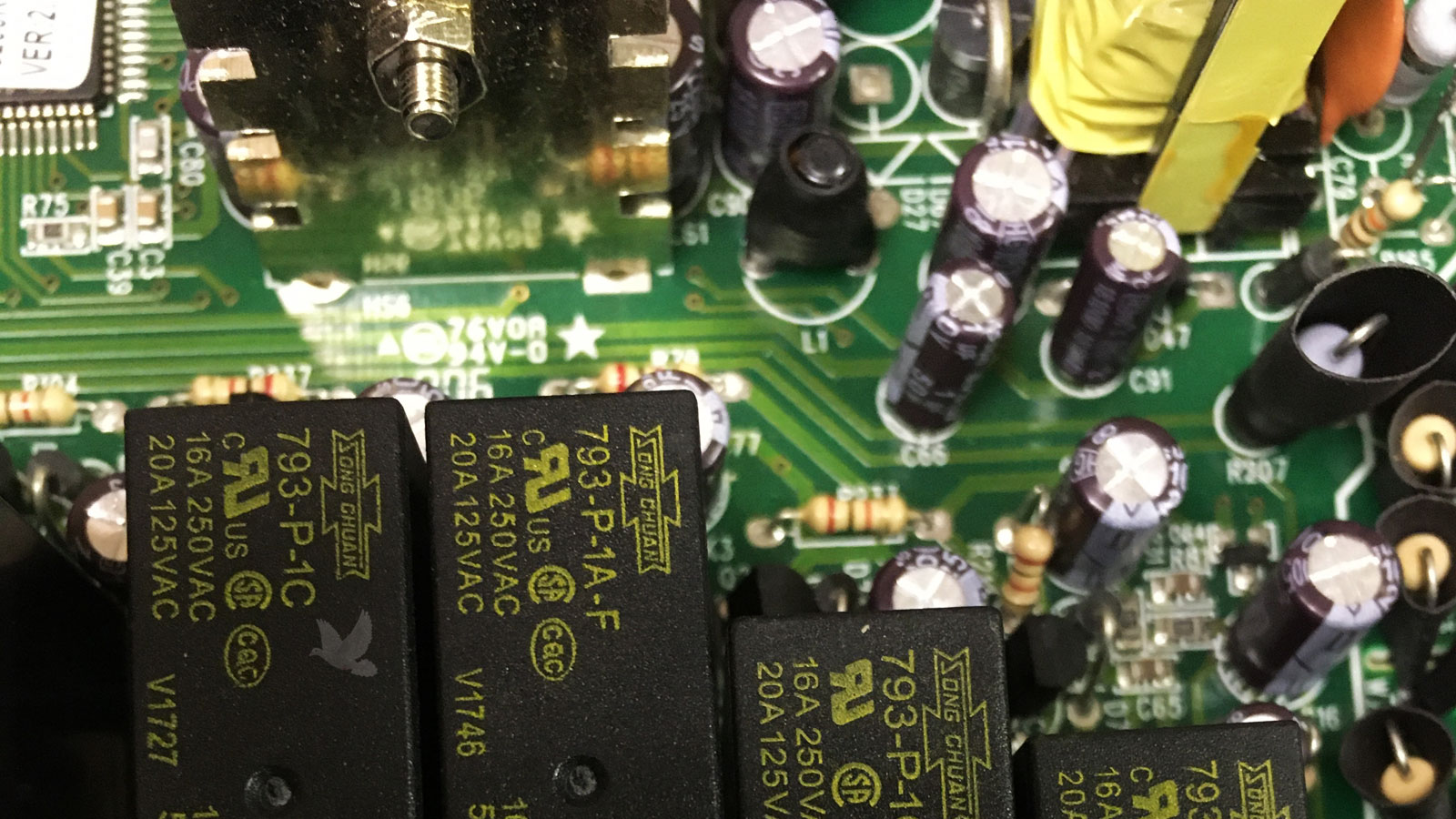 Five-relay circuit board with damaged second relay marked with X