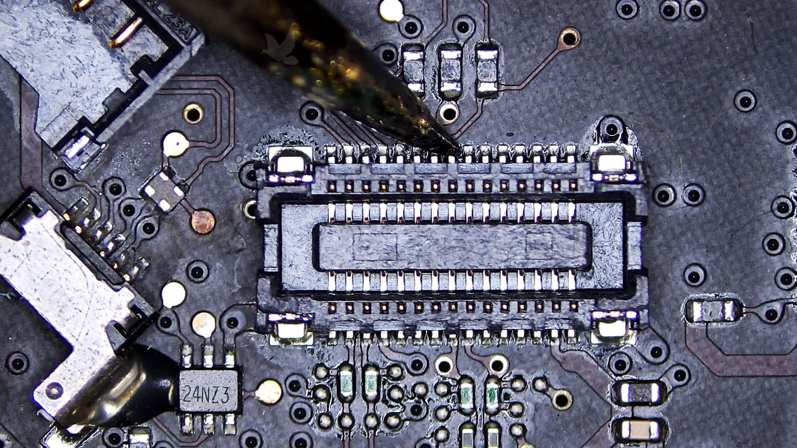 Soldering iron resoldering a pin on an FFC connector to restore electrical connectivity