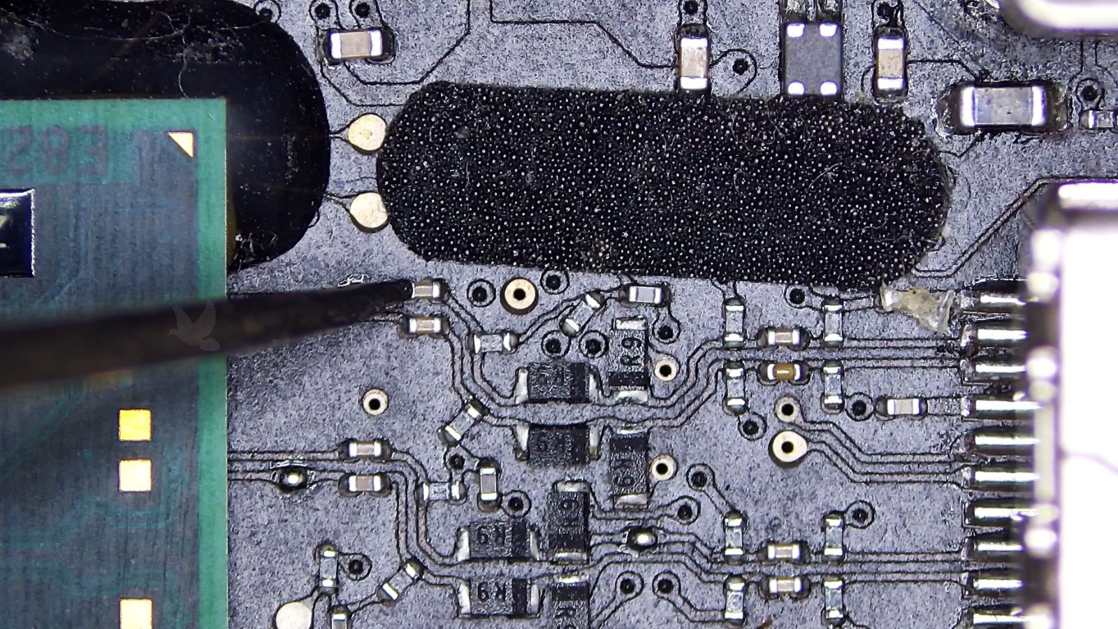Tiny damaged capacitor hidden between the GPU and nearby connector