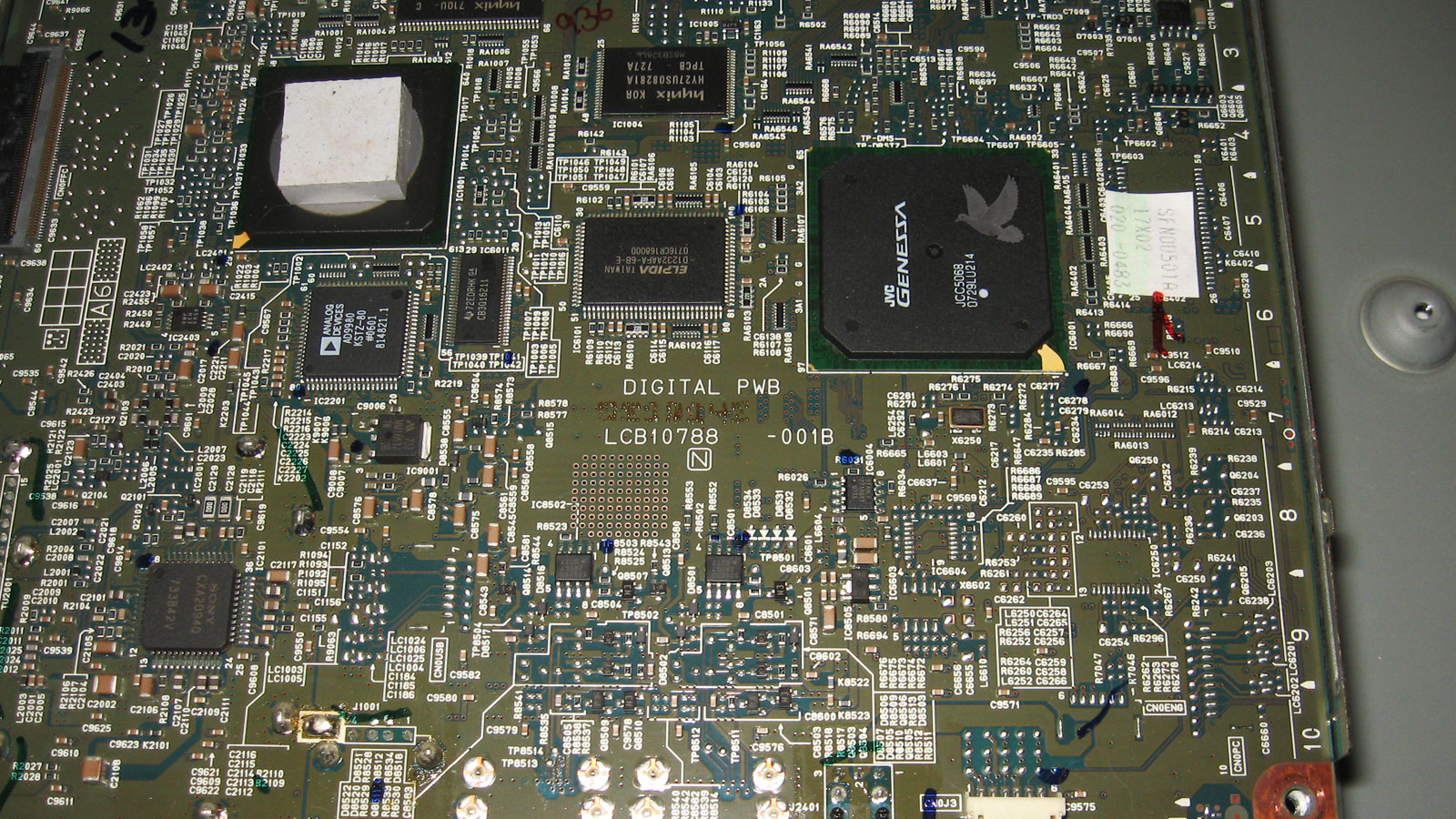 Circuit board showing a JVC Genessa main processor that fails to start due to a damaged Hynix NAND flash memory chip.