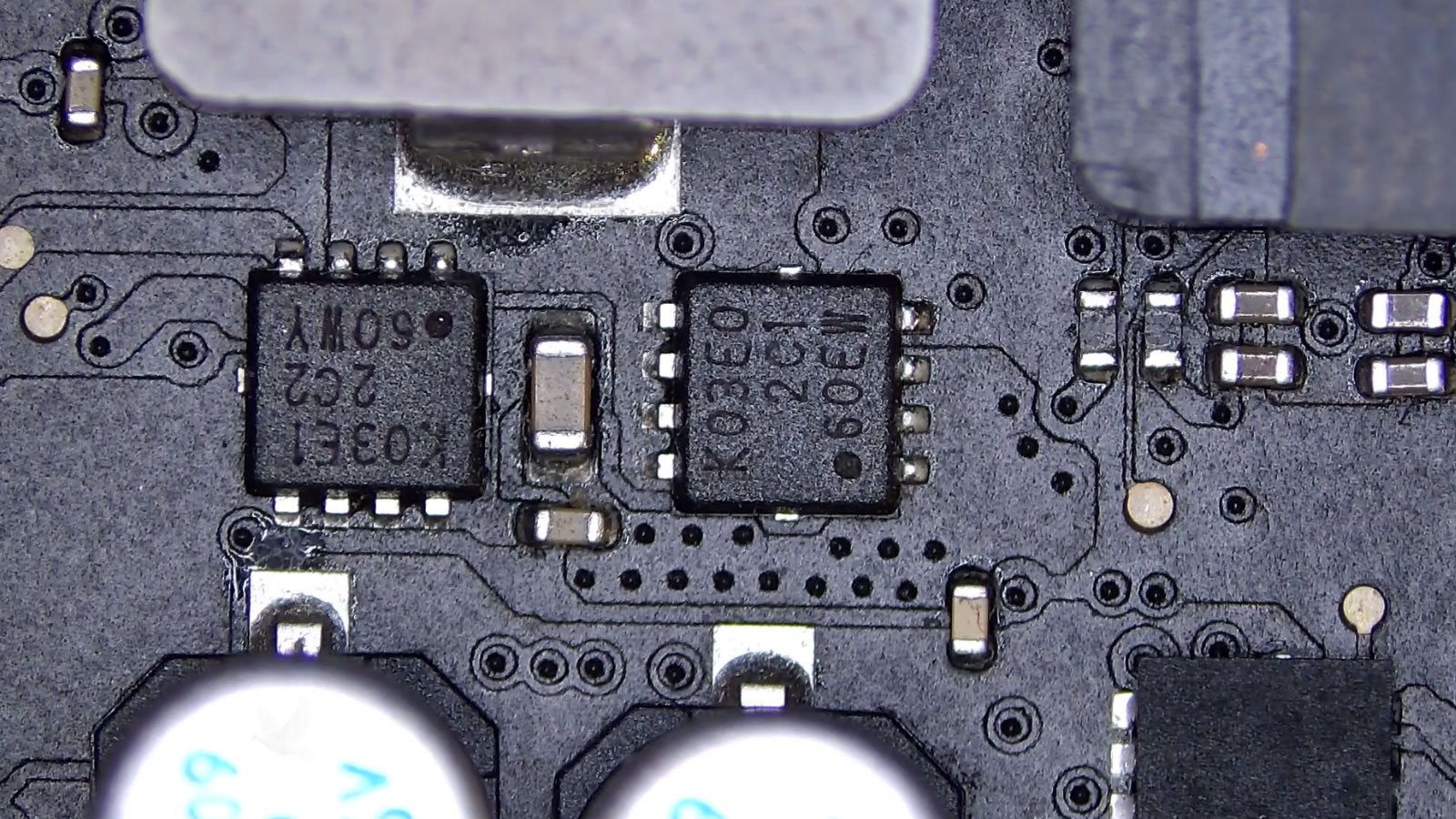 Two K03E0 MOSFETs replaced on a circuit board to restore computer operation