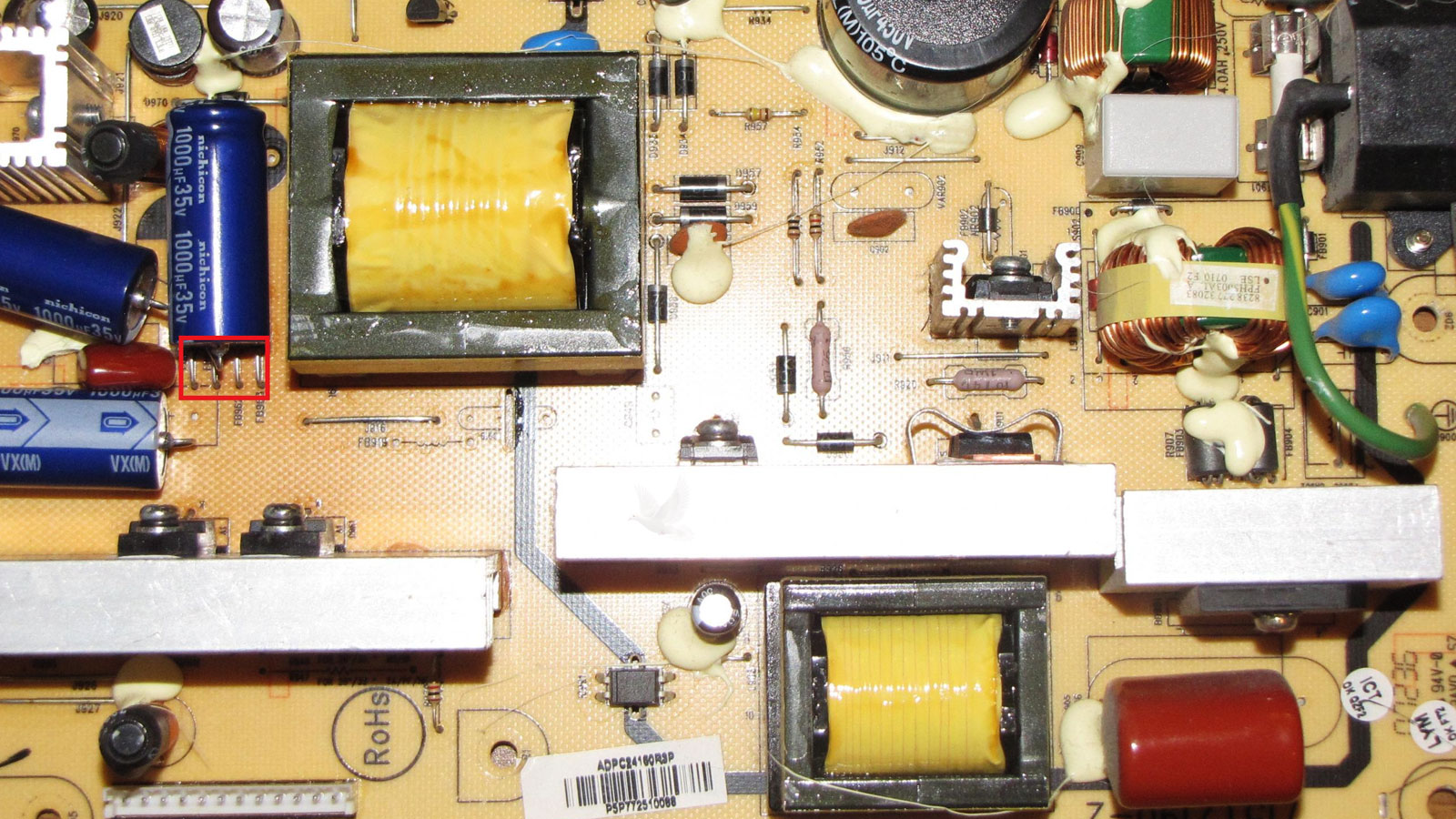 Leaking Nichicon 1000uF 35V capacitor lying horizontally on power circuit board