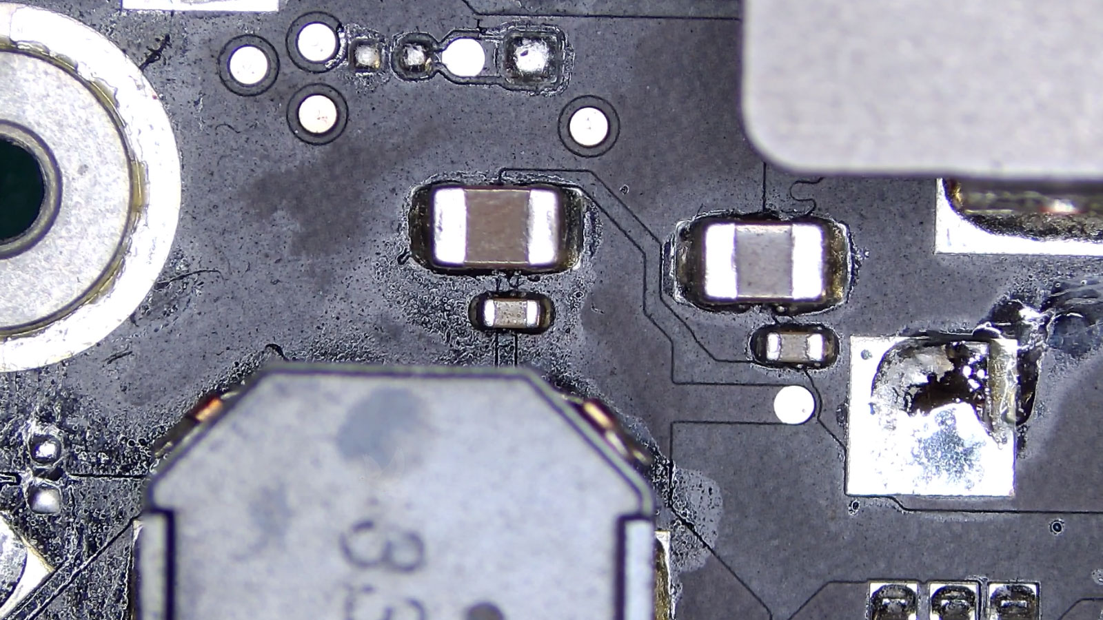 Liquid-damaged circuit board with corrosion and failed IC removed for replacement
