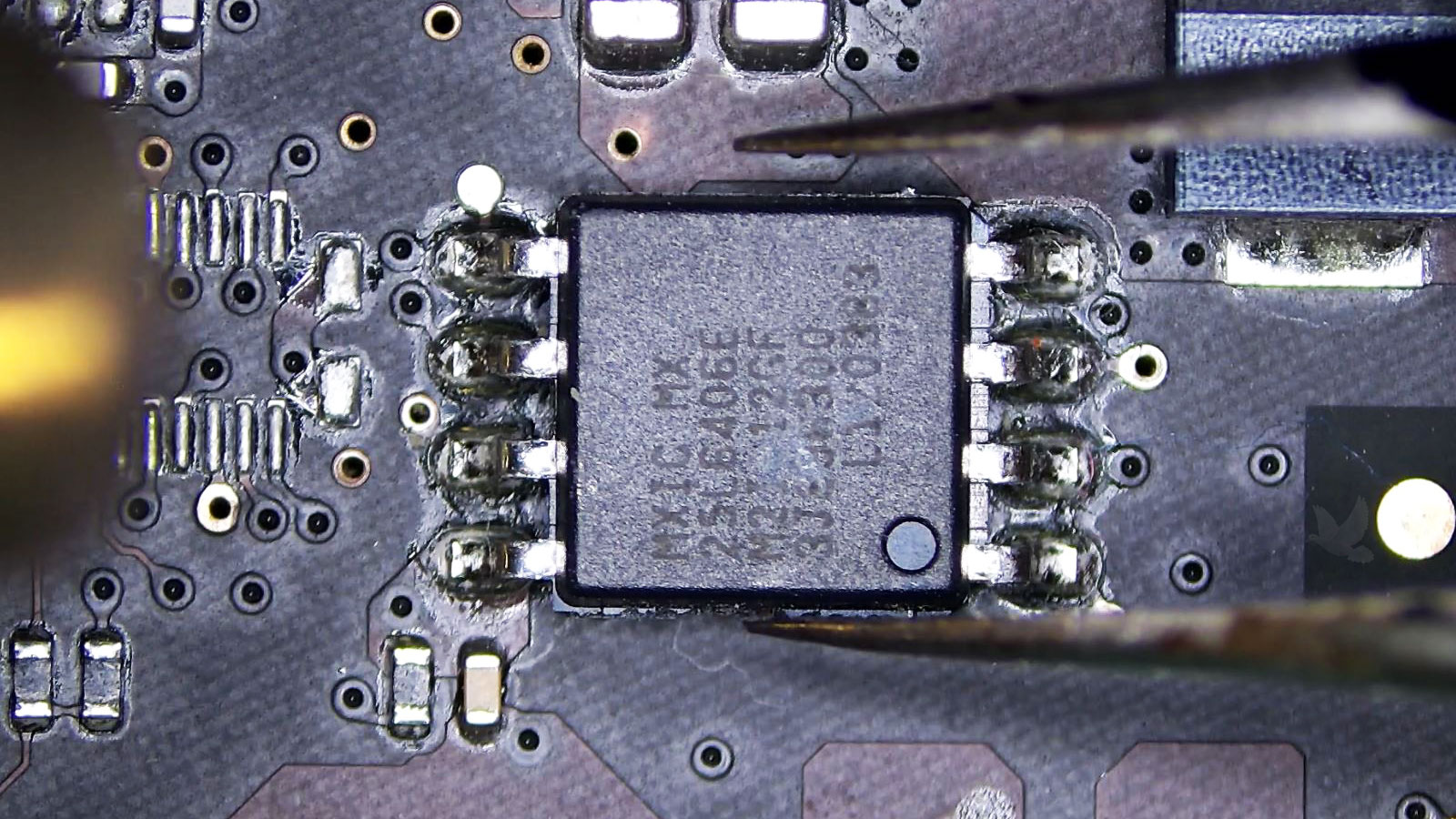MX25L6406E CMOS serial flash IC being removed with tweezers and hot air