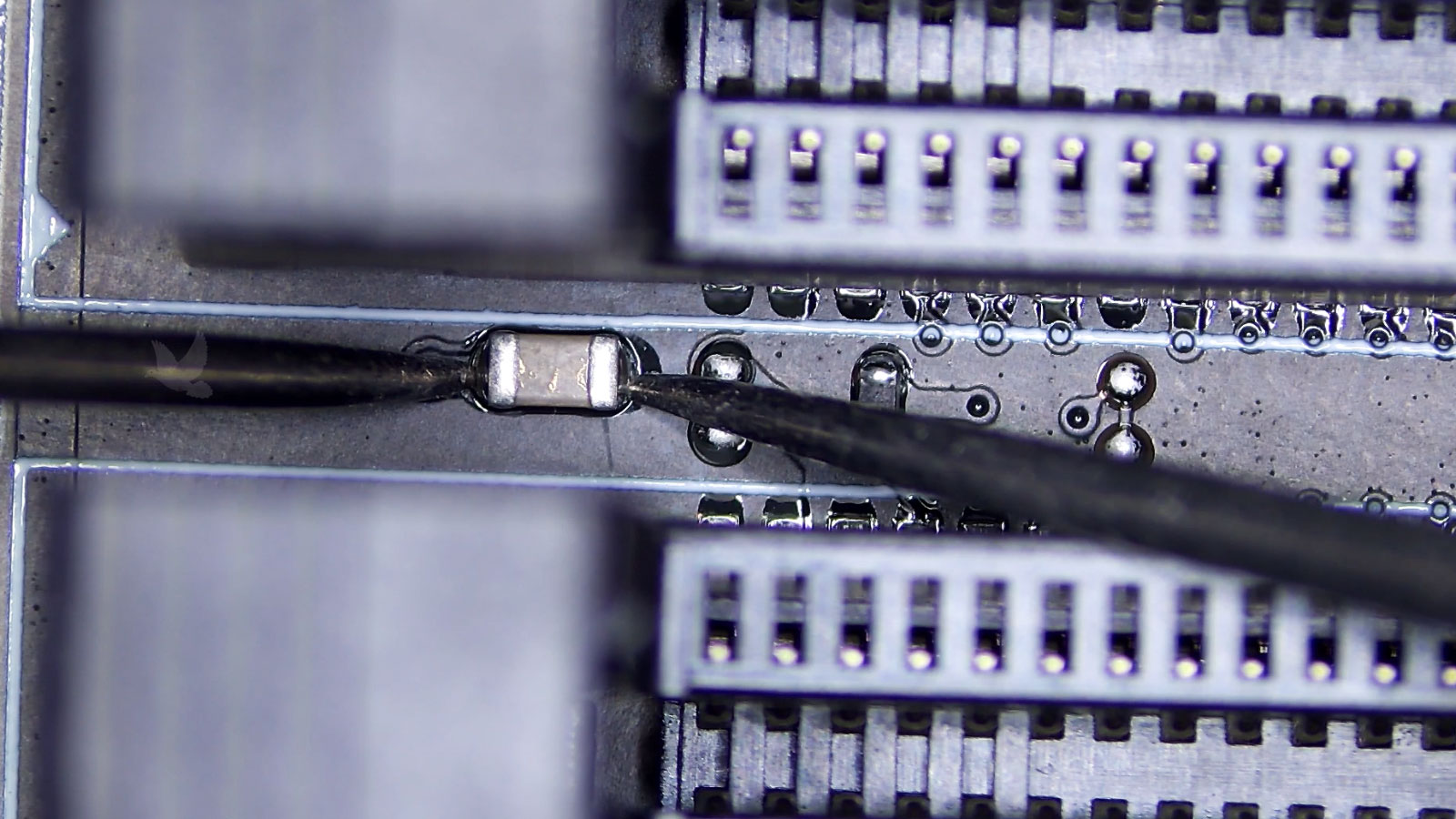 Shorted capacitor identified between two PC memory sockets during motherboard testing