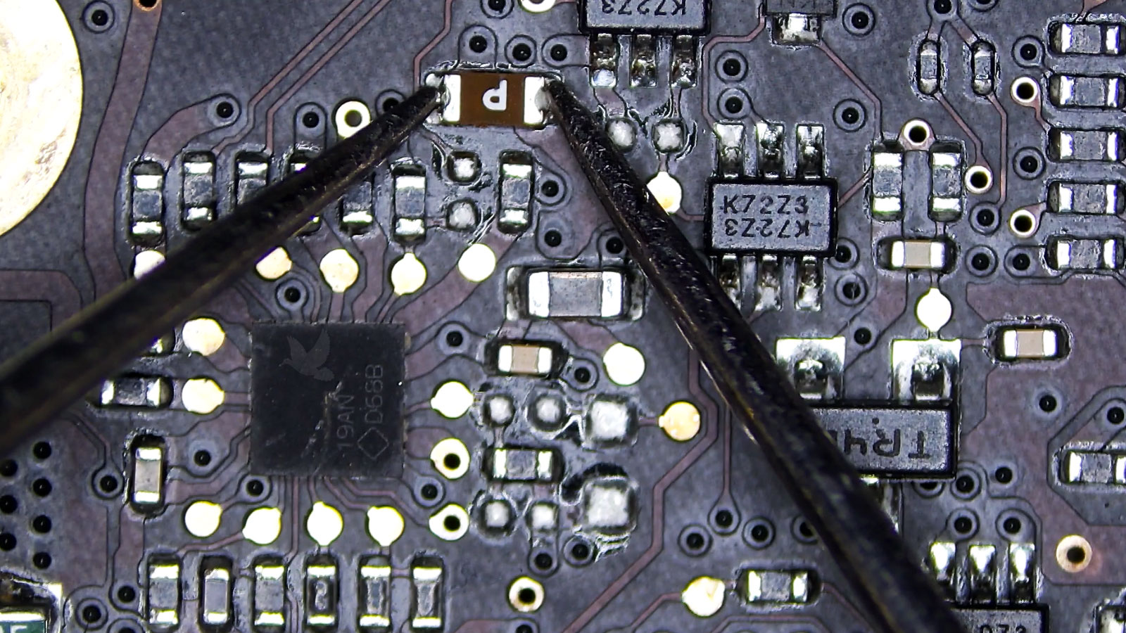 Brown P-marked fuse being measured open on a computer circuit board