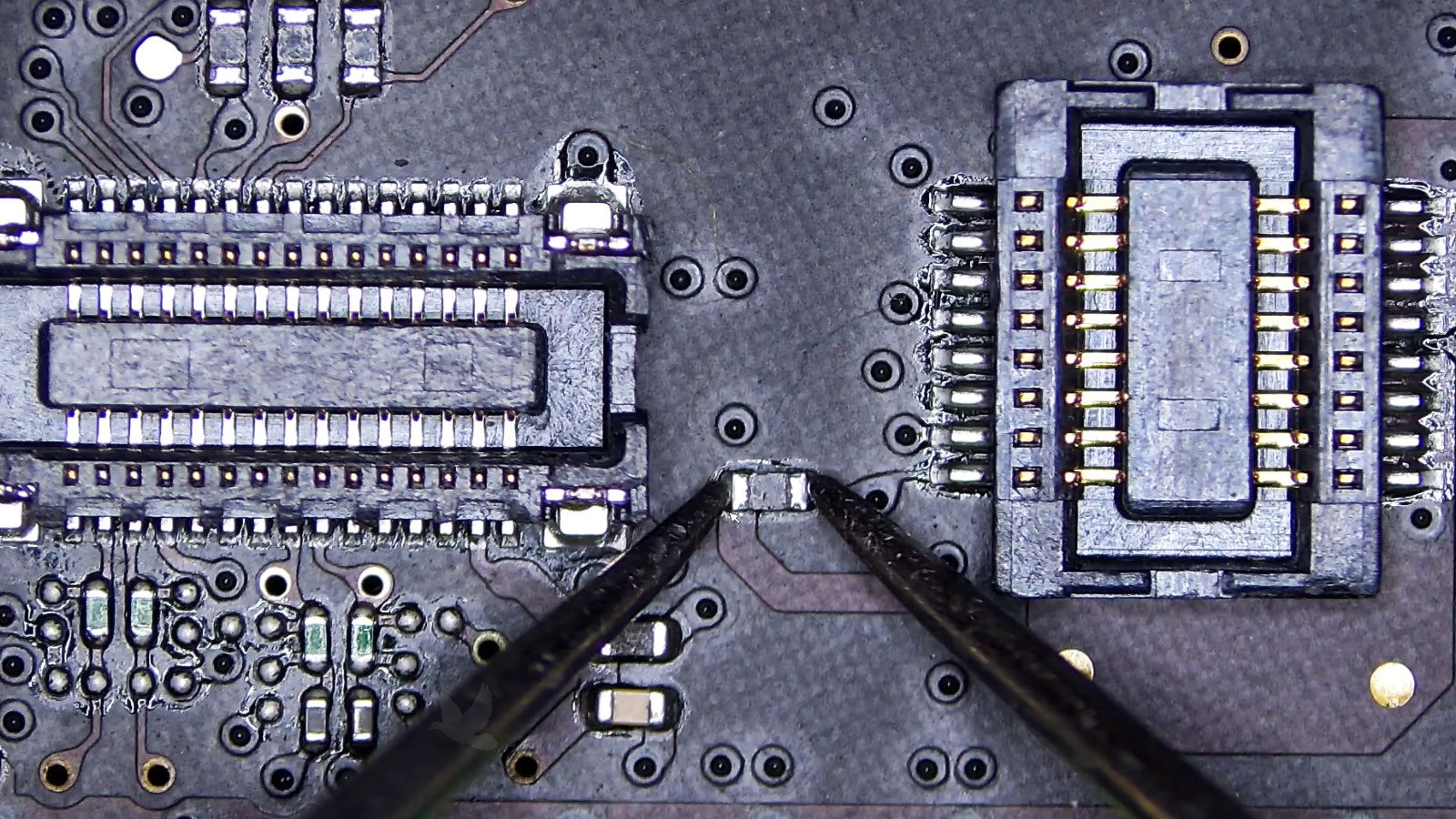 Resistor being measured and found open between two FFC connectors on a computer circuit board