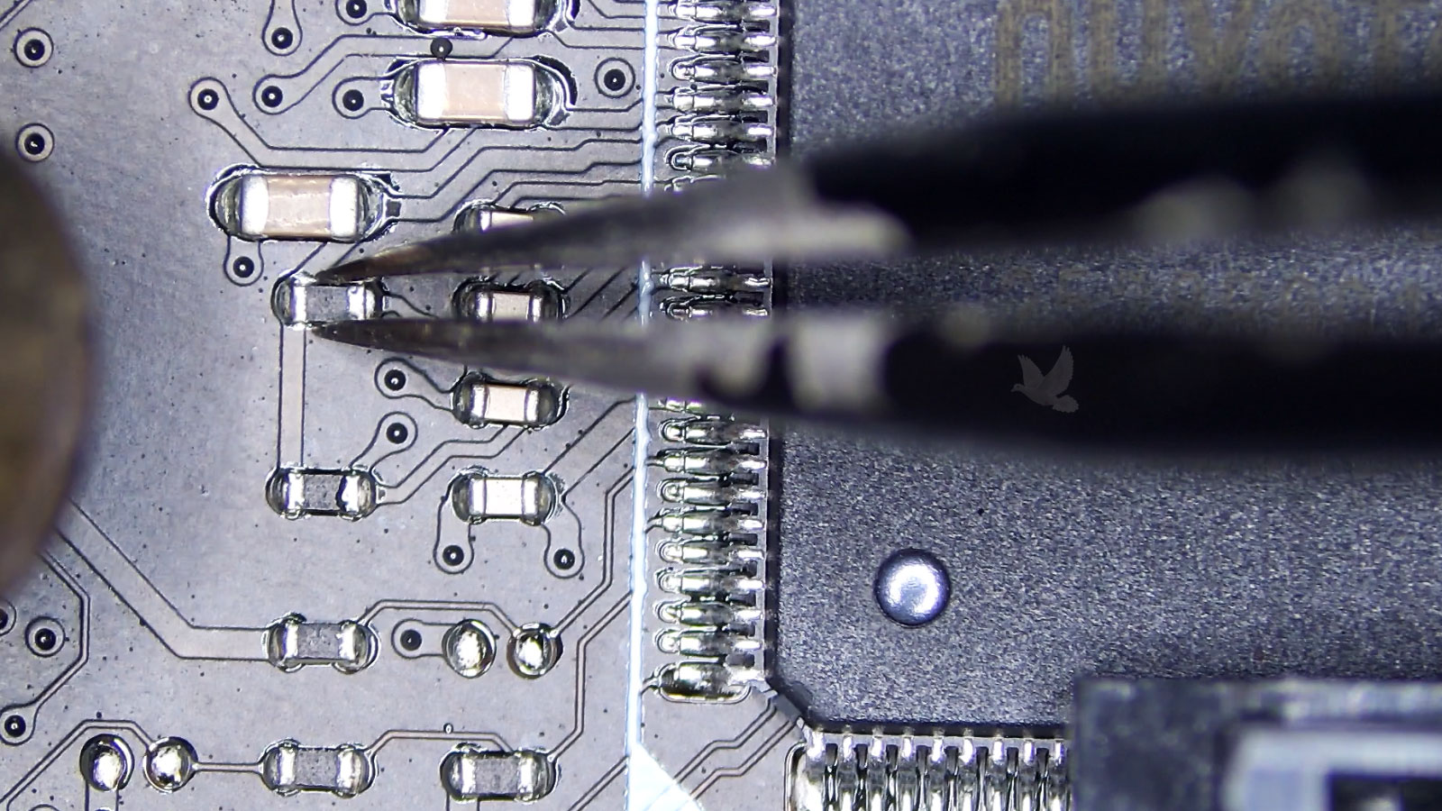 Open resistor being removed with hot air near a large IC chip